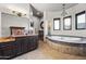 Luxurious bathroom with jacuzzi tub, dual sinks, dark cabinets, and ample counter space at 13931 E Via Linda --, Scottsdale, AZ 85259