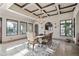 Bright dining room featuring coffered ceilings, chandelier, travertine floors, and large windows with desert views at 13931 E Via Linda --, Scottsdale, AZ 85259