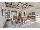 Formal dining room featuring coffered ceilings, chandelier, travertine floors, and designer furnishings at 13931 E Via Linda --, Scottsdale, AZ 85259