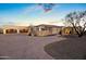 Stunning desert home with a circular driveway and manicured landscaping, showcasing an inviting entrance and ample parking at 13931 E Via Linda --, Scottsdale, AZ 85259