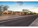 Stunning desert home with stone accents, lush landscaping, and a wide driveway, capturing the essence of luxury living at 13931 E Via Linda --, Scottsdale, AZ 85259