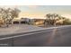 Charming desert home with stone accents, a spacious driveway, and lush desert landscaping, offering curb appeal at 13931 E Via Linda --, Scottsdale, AZ 85259