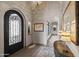 Elegant entryway featuring wrought iron door, arched doorways, travertine floors, and stylish decor at 13931 E Via Linda --, Scottsdale, AZ 85259