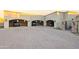 Large three-car garage with brick driveway and decorative sconces, each bay equipped with a vehicle at 13931 E Via Linda --, Scottsdale, AZ 85259