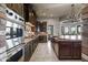 This kitchen features an oven, range, brick backsplash, and plenty of cabinet space at 13931 E Via Linda --, Scottsdale, AZ 85259