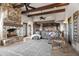 Open-concept living room and kitchen with stone fireplace and comfortable seating area at 13931 E Via Linda --, Scottsdale, AZ 85259