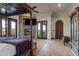 Spacious primary bedroom with fireplace, canopy bed, and access to outdoor space at 13931 E Via Linda --, Scottsdale, AZ 85259