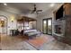 Luxurious primary bedroom with stone fireplace, travertine flooring, sitting area, and outdoor access at 13931 E Via Linda --, Scottsdale, AZ 85259