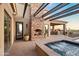 A cozy outdoor fireplace and sitting area complement the jacuzzi and outdoor kitchen in this backyard at 13931 E Via Linda --, Scottsdale, AZ 85259