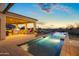 Outdoor area with a covered patio, outdoor kitchen, pool, and manicured landscape, ideal for relaxing and dining at 13931 E Via Linda --, Scottsdale, AZ 85259