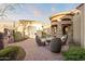 Charming outdoor patio with stone accents, seating area, and well-manicured landscaping at 13931 E Via Linda --, Scottsdale, AZ 85259