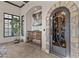 A beautiful custom wine cellar with a decorative iron door and ample wine storage at 13931 E Via Linda --, Scottsdale, AZ 85259