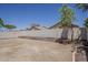 Large backyard area featuring a retaining wall and a privacy fence at 15364 W Acapulco Ln, Surprise, AZ 85379
