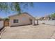 Spacious backyard featuring a covered patio and secure gate access at 15364 W Acapulco Ln, Surprise, AZ 85379