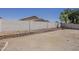 Large backyard space featuring a decorative block wall, offering privacy and landscaping potential at 15364 W Acapulco Ln, Surprise, AZ 85379