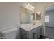 Well-lit bathroom with a modern vanity and a view into another room at 15364 W Acapulco Ln, Surprise, AZ 85379
