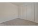 Minimalist bedroom with sliding closet doors and neutral carpet at 15364 W Acapulco Ln, Surprise, AZ 85379