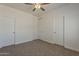 Neutral bedroom featuring carpet flooring, white walls, and a ceiling fan at 15364 W Acapulco Ln, Surprise, AZ 85379