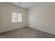 Bedroom featuring neutral carpet, a window, and neutral walls at 15364 W Acapulco Ln, Surprise, AZ 85379