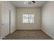 Bright bedroom with neutral carpet and a window overlooking the yard at 15364 W Acapulco Ln, Surprise, AZ 85379