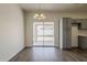 Dining area features wood-look floors and grey cabinets, blending style and practicality in a well-lit space at 15364 W Acapulco Ln, Surprise, AZ 85379