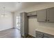 Open dining area with grey cabinets, light countertops, and a sliding glass door, perfect for modern living and entertaining at 15364 W Acapulco Ln, Surprise, AZ 85379