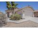 Single-story home with desert landscaping, beige stucco, and a two-car garage at 15364 W Acapulco Ln, Surprise, AZ 85379