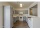 Well-lit kitchen features stainless appliances, grey cabinets, and light countertops, offering a modern and functional space at 15364 W Acapulco Ln, Surprise, AZ 85379