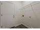 Laundry room with a door, connections for a washer/dryer, and a shelf at 15364 W Acapulco Ln, Surprise, AZ 85379