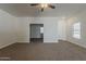 Living room with neutral walls, ceiling fan and carpet, and white trim at 15364 W Acapulco Ln, Surprise, AZ 85379