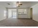 Open-concept living room with carpet and view of kitchen and dining area at 15364 W Acapulco Ln, Surprise, AZ 85379