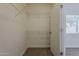 Walk-in closet with shelving, storage, and a view into the bedroom at 15364 W Acapulco Ln, Surprise, AZ 85379