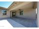 Covered back patio with a ceiling fan, offering a shady retreat and access to the backyard at 16475 N 183Rd Dr, Surprise, AZ 85388