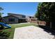 Expansive backyard with artificial grass, brick-paver patio, and partial view of the home's rear exterior at 16475 N 183Rd Dr, Surprise, AZ 85388