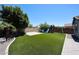 A backyard with synthetic grass, pavers, mature trees and a playground at 16475 N 183Rd Dr, Surprise, AZ 85388