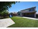 Large backyard featuring artificial turf, a playground set, and a covered patio area at 16475 N 183Rd Dr, Surprise, AZ 85388