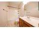 Traditional bathroom featuring a wood vanity, a shower-tub combo, and tile flooring at 16475 N 183Rd Dr, Surprise, AZ 85388