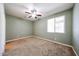 Neutral bedroom with carpet flooring, a ceiling fan, and a window offering natural light at 16475 N 183Rd Dr, Surprise, AZ 85388