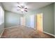 A bright bedroom showcases neutral carpet, fresh paint, and an ensuite bathroom for convenience at 16475 N 183Rd Dr, Surprise, AZ 85388