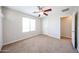 The bedroom has a neutral color scheme, plush carpeting, and a ceiling fan at 16475 N 183Rd Dr, Surprise, AZ 85388