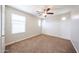 Bedroom featuring a ceiling fan, a large window, and neutral carpeting at 16475 N 183Rd Dr, Surprise, AZ 85388