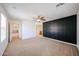 A spacious bedroom featuring a modern ceiling fan and a stylish dark accent wall at 16475 N 183Rd Dr, Surprise, AZ 85388