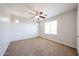 This is a bright bedroom with wainscoting and a ceiling fan at 16475 N 183Rd Dr, Surprise, AZ 85388