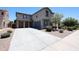 Home featuring a long driveway leading to a two-car garage, with desert landscaping at 16475 N 183Rd Dr, Surprise, AZ 85388