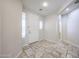 Bright foyer with travertine tile flooring, natural light, and a view into the house at 16475 N 183Rd Dr, Surprise, AZ 85388