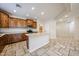 Spacious kitchen featuring stainless steel appliances, wood cabinets, and a central island at 16475 N 183Rd Dr, Surprise, AZ 85388