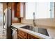 Kitchen sink with a view of the stainless steel fridge and the eat-in kitchen area at 16475 N 183Rd Dr, Surprise, AZ 85388