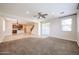 Carpeted living room flowing into a kitchen and dining area, perfect for entertaining at 16475 N 183Rd Dr, Surprise, AZ 85388