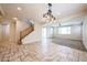 Open living area with a view of the staircase, dining area, and modern chandelier at 16475 N 183Rd Dr, Surprise, AZ 85388