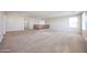 Expansive loft area with neutral walls, carpet flooring, and a wooden railing at 16475 N 183Rd Dr, Surprise, AZ 85388